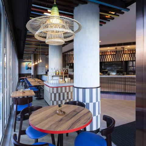 An interior perspective showcasing custom tiling, timber furniture, and statement lighting.