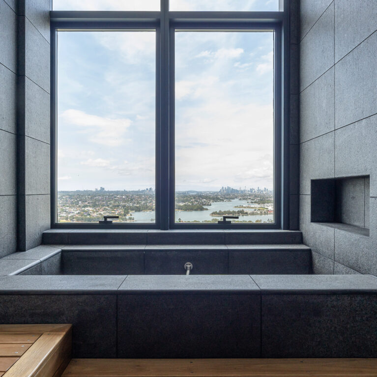 A custom-designed bath with expansive views, blending luxury finishes and serene scenery for a truly relaxing experience.