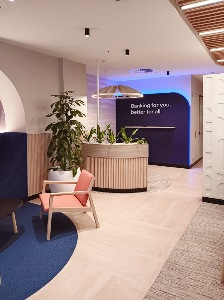 The mission statement wall, designed with calming colors and modern textures for a welcoming bank branch.