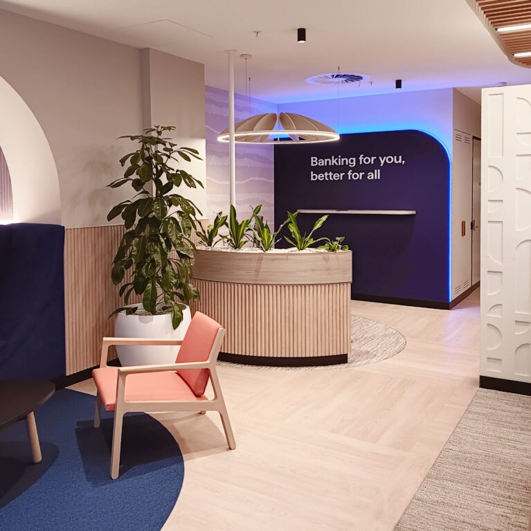 The mission statement wall, designed with calming colors and modern textures for a welcoming bank branch.