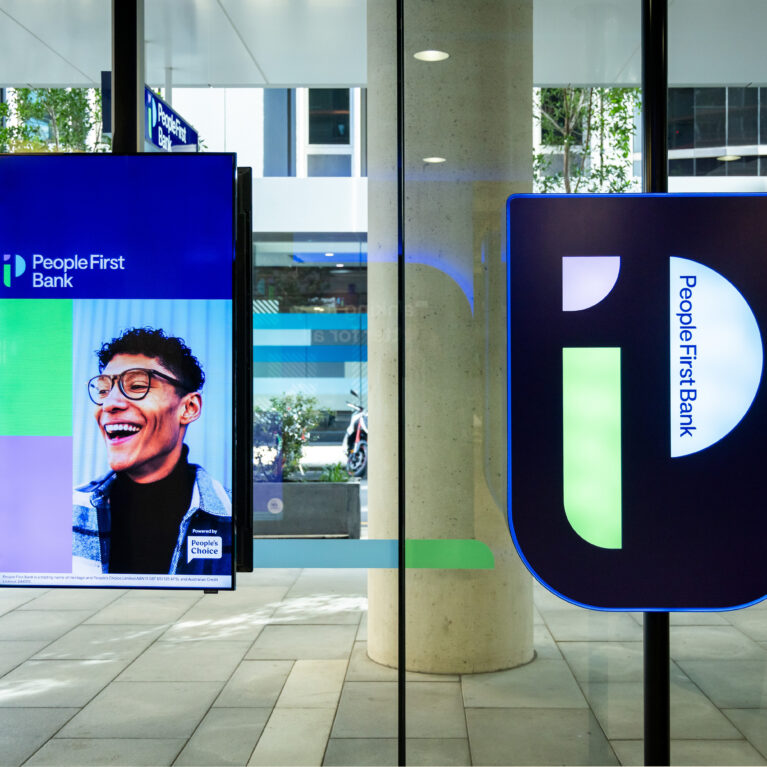 A vibrant digital display greets visitors, showcasing People First Bank’s commitment to community and inclusivity.