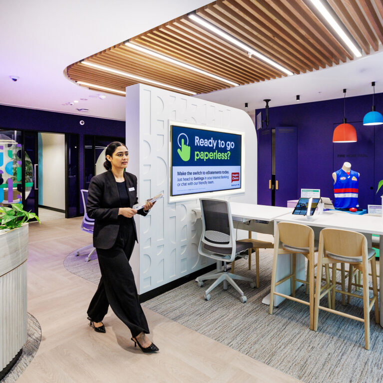 This open-plan workspace redefines banking environments with clean lines, a light warm palette, and flexible seating options. Contemporary design elements like textured walls, natural wood tones, and integrated greenery create a modern, approachable, and inclusive atmosphere for staff and visitors alike.