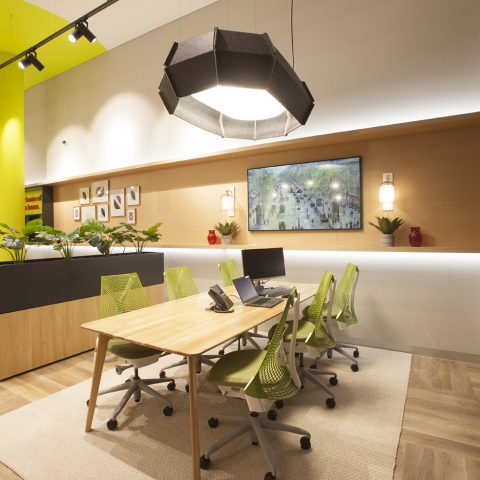 A dedicated advisory zone featuring ergonomic seating and a bespoke timber meeting table.