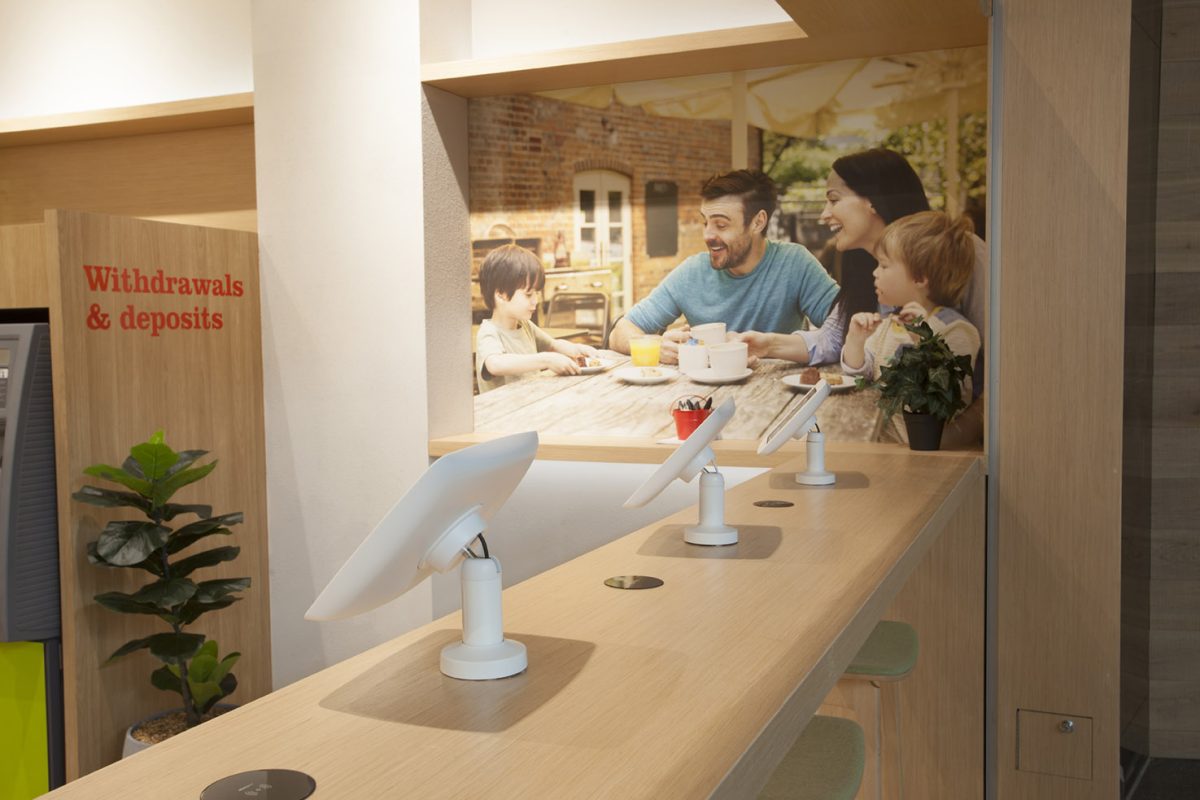 A streamlined service bar featuring integrated touchscreens and community-focused imagery.