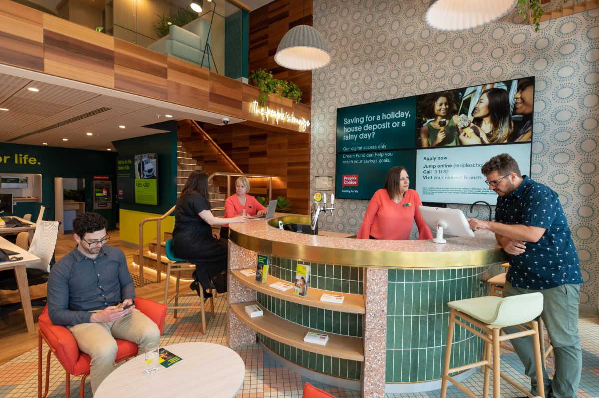 The welcoming bar area at People’s Choice bank, featuring a teal-tiled counter, stylish seating, and a vibrant, open atmosphere.