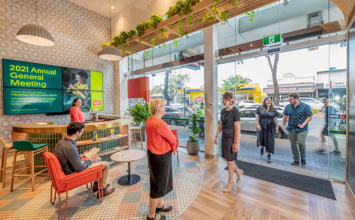A view of People’s Choice bank’s bright and welcoming lobby, with open seating, natural light, and modern decor looking toward the main entrance.