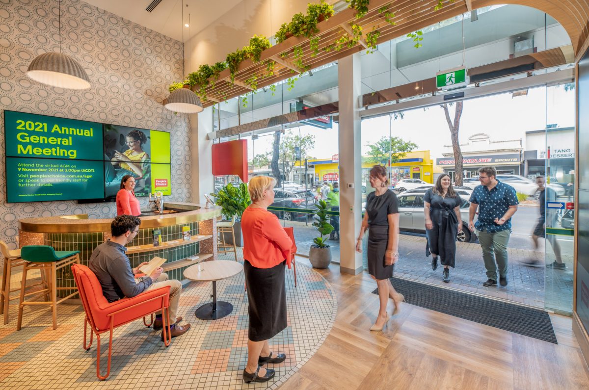 A view of People’s Choice bank’s bright and welcoming lobby, with open seating, natural light, and modern decor looking toward the main entrance.