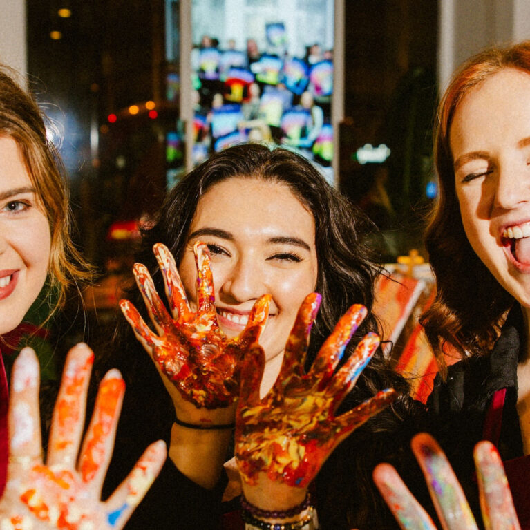 Laughter, color, and creativity come to life as guests embrace the joy of painting. With hands covered in vibrant paint, they capture the playful and immersive spirit of the experience, where self-expression and shared moments take center stage.