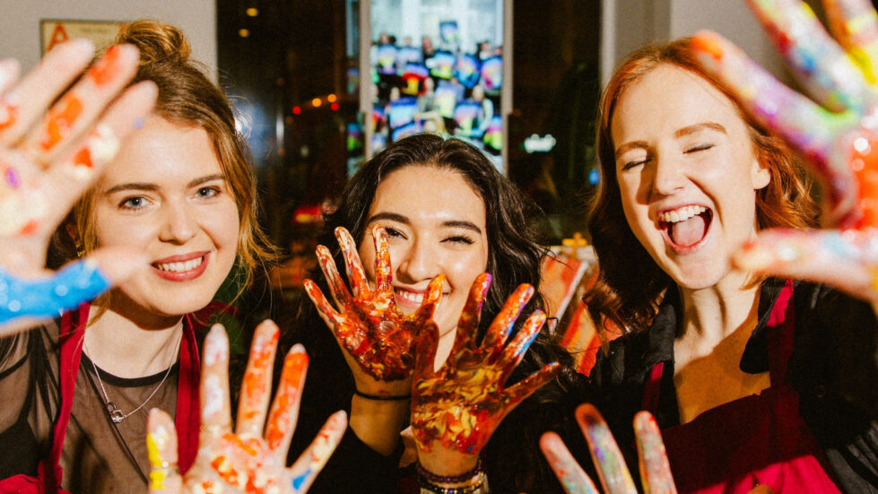 Laughter, color, and creativity come to life as guests embrace the joy of painting. With hands covered in vibrant paint, they capture the playful and immersive spirit of the experience, where self-expression and shared moments take center stage.