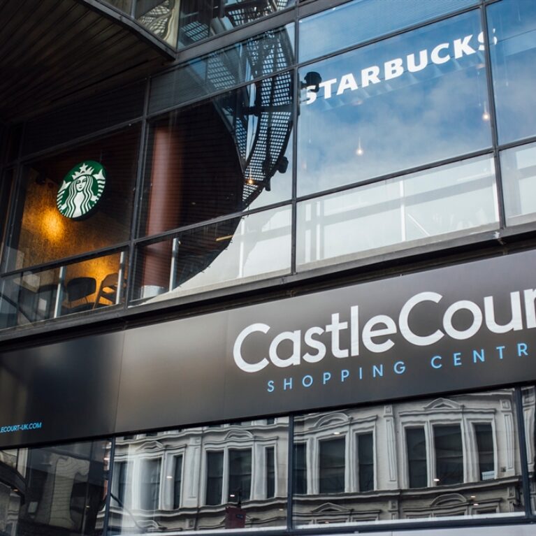 A dynamic view of CastleCourt Shopping Centre’s façade, where high-traffic retail frontage meets everyday visitor flow.
