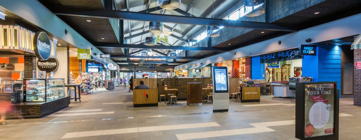 An expansive internal overview showing structured storefront interfaces and central seating clusters.