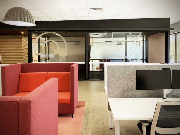 Upper-level workstations with collaborative seating and private meeting spaces.