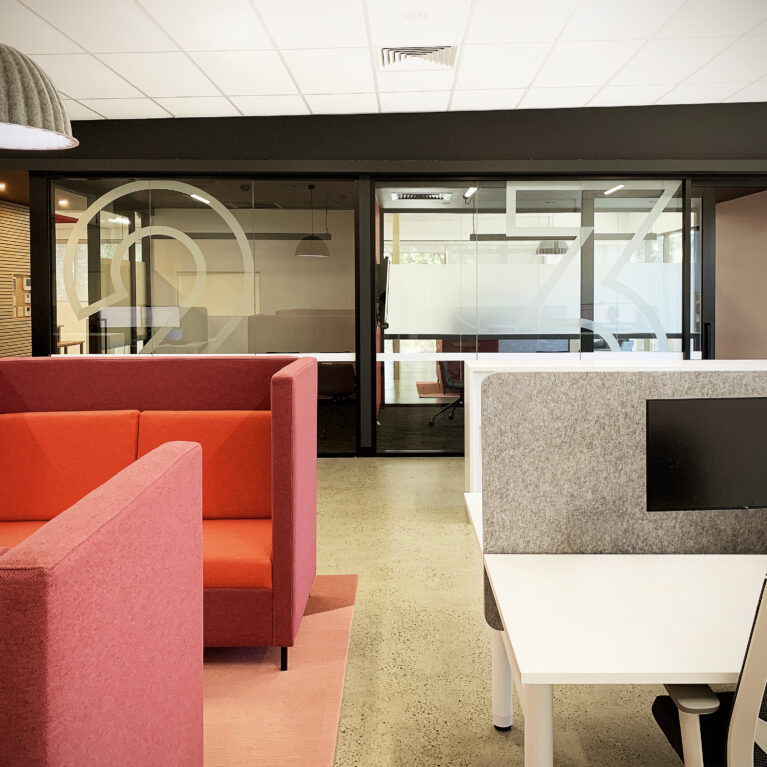 Upper-level workstations with collaborative seating and private meeting spaces.