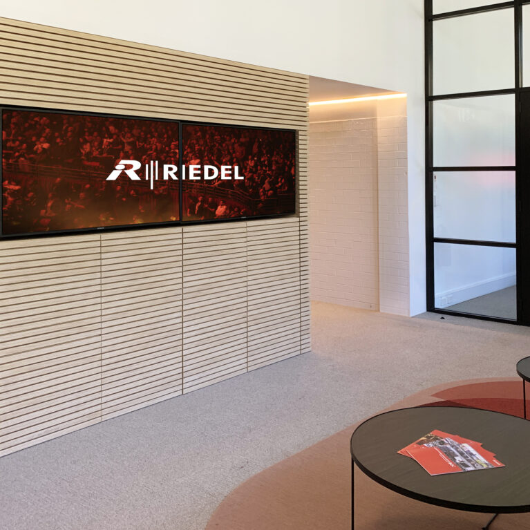 Entrance lobby featuring a slatted accent wall and modern seating, creating a refined and welcoming entry space.