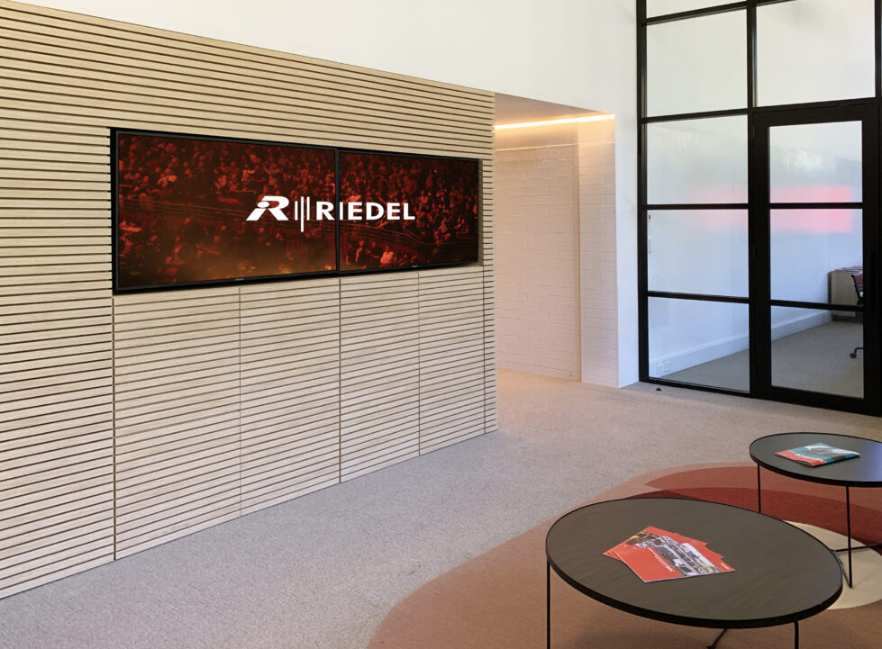 Entrance lobby featuring a slatted accent wall and modern seating, creating a refined and welcoming entry space.