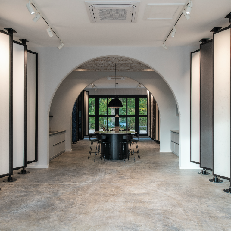 An open-plan showroom at The Mason’s Yard, featuring archways that create distinct display zones and offer layered perspectives.