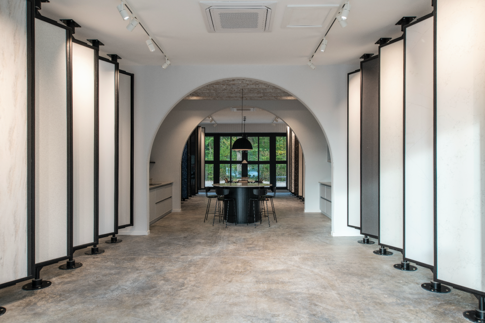 An open-plan showroom at The Mason’s Yard, featuring archways that create distinct display zones and offer layered perspectives.