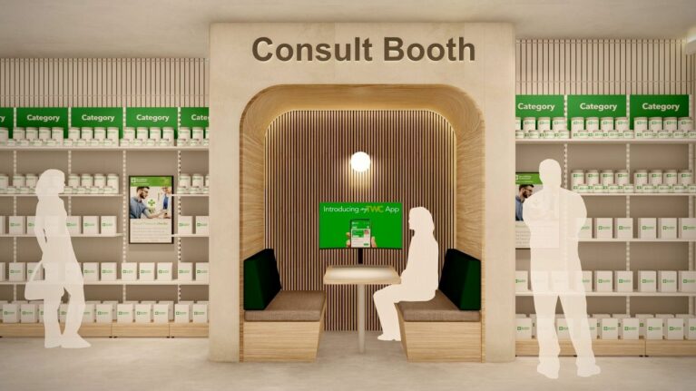 A timber-lined booth with built-in seating, soft lighting, and a digital screen, offering a semi-private space for one-to-one health or wellness discussions inside the store.