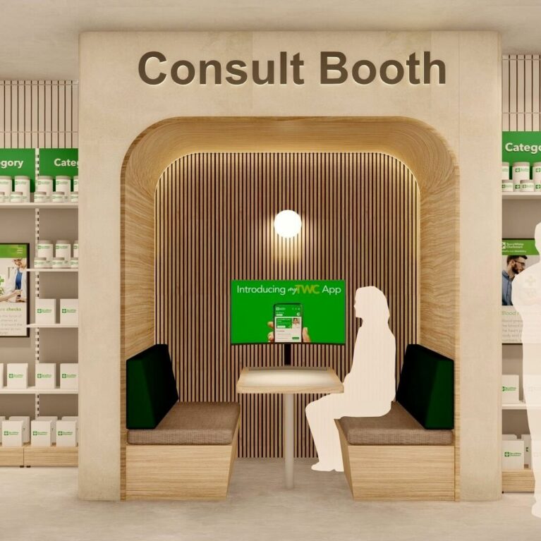 A timber-lined booth with built-in seating, soft lighting, and a digital screen, offering a semi-private space for one-to-one health or wellness discussions inside the store.