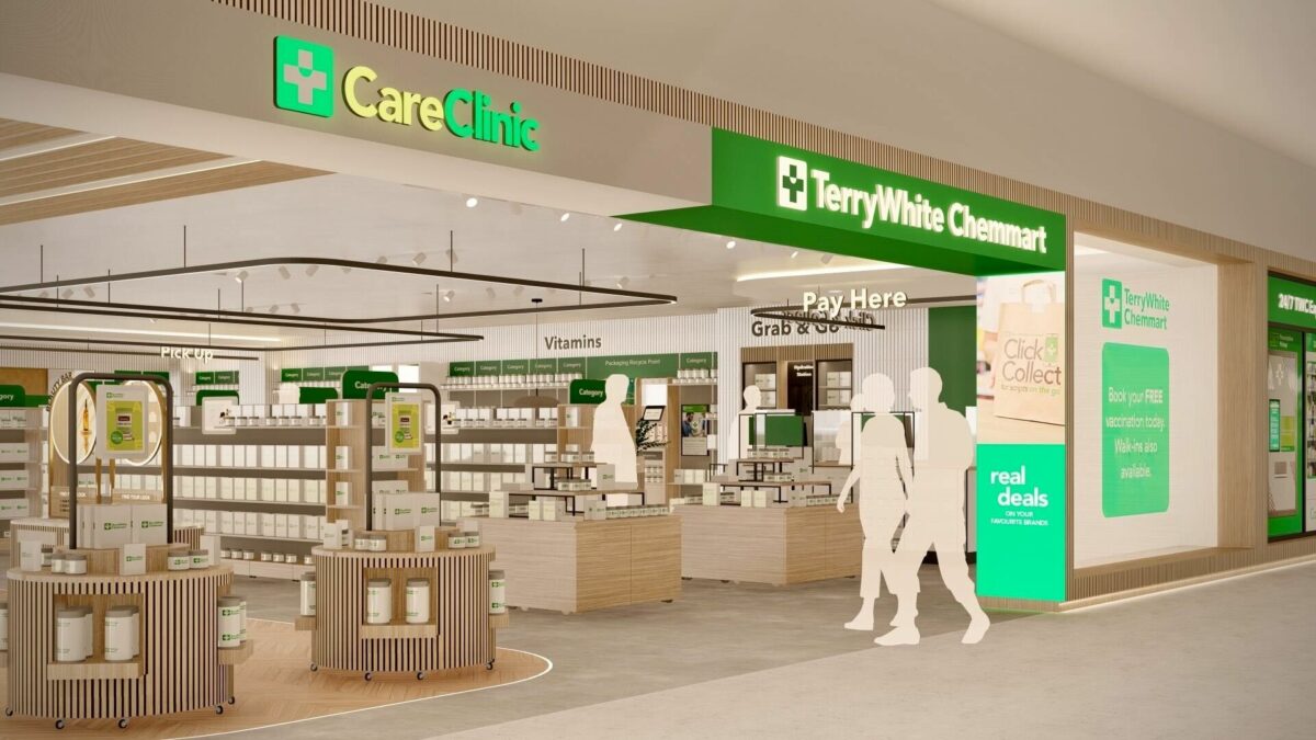 An open view through the TerryWhite Chemmart entrance, framed by bright signage and flexible display pods on wheels that guide customers toward vitamins, Grab & Go and the Pay Here counter.