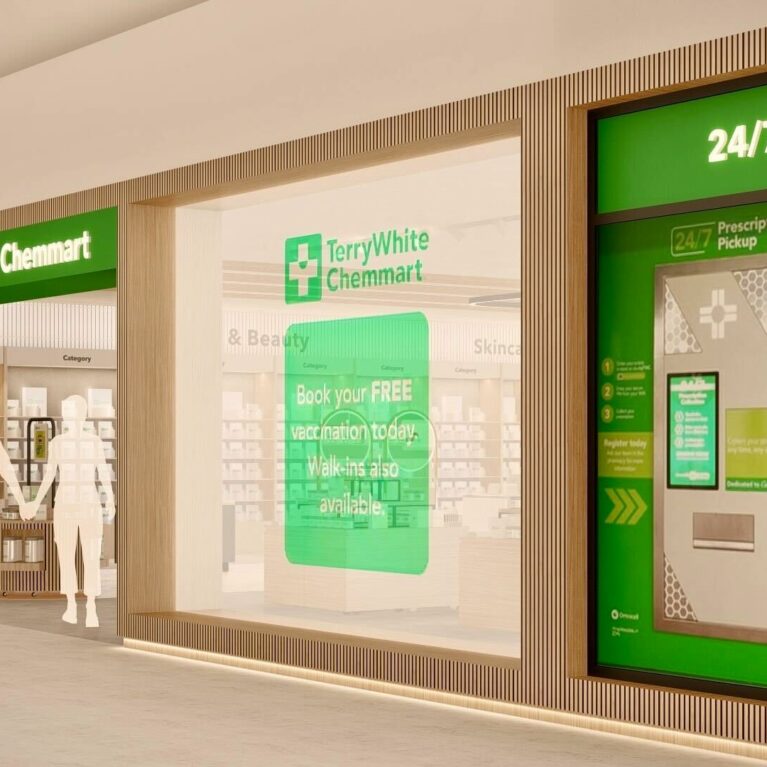 A clear exterior view of the TerryWhite Chemmart store, highlighting its glass façade, illuminated signage, and integrated 24/7 TWC Express prescription pickup kiosk for round-the-clock service.