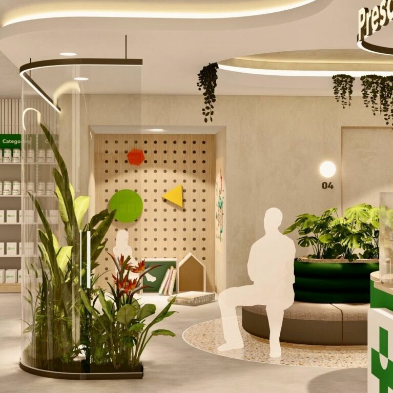 A calm waiting area with curved seating, lush planting, and a children’s play corner, positioned adjacent to the prescription counter to create a welcoming, family-oriented environment.