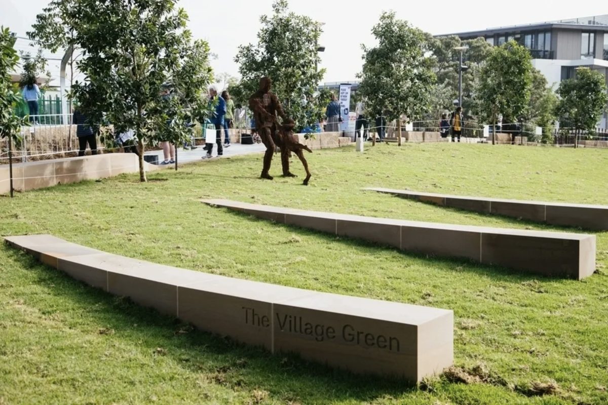 A landscaped park area with stone benches and greenery, creating a peaceful urban retreat.