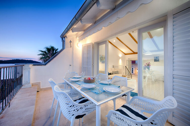 A spacious dining terrace with stunning sea views. Modern outdoor furniture and clean design invite guests to relax, dine, and take in the beauty of the Adriatic coast.