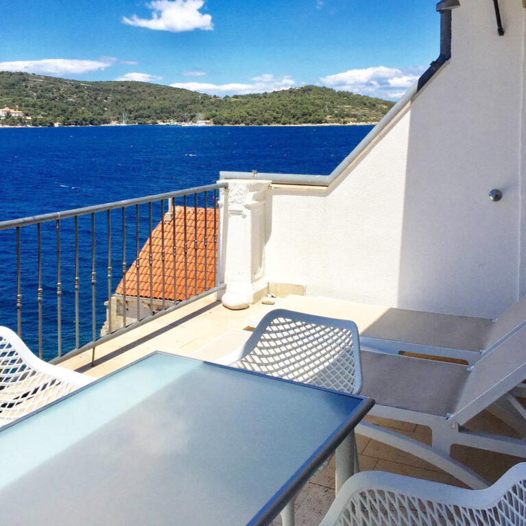 A spacious dining terrace with stunning sea views. Modern outdoor furniture and clean design invite guests to relax, dine, and take in the beauty of the Adriatic coast.