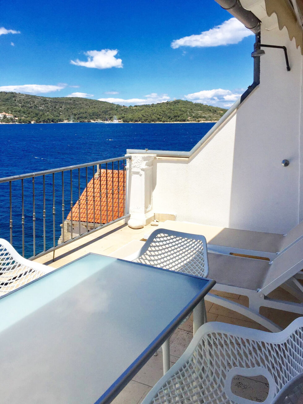 A spacious dining terrace with stunning sea views. Modern outdoor furniture and clean design invite guests to relax, dine, and take in the beauty of the Adriatic coast.