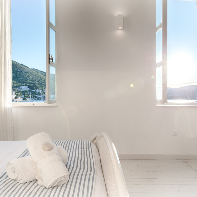 A calm, light-filled guest suite overlooking the Adriatic coastline.