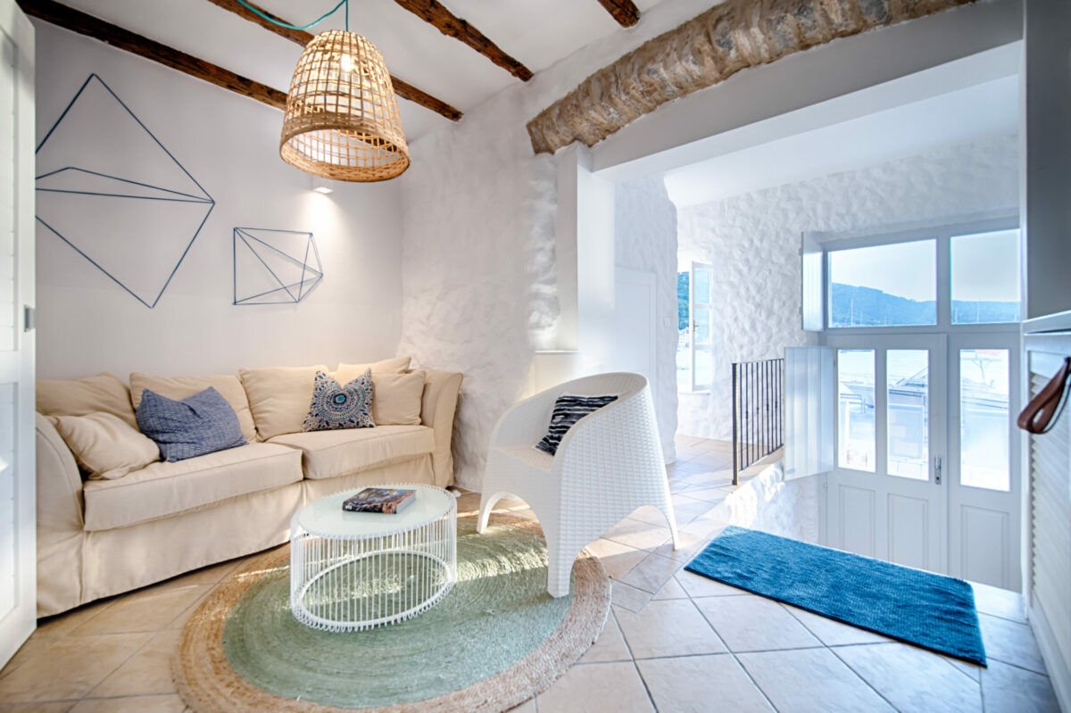 A cozy corner featuring natural textures, warm lighting, and artistic decor. This intimate space combines rustic beams with modern furnishings, creating a perfect balance of comfort and design.