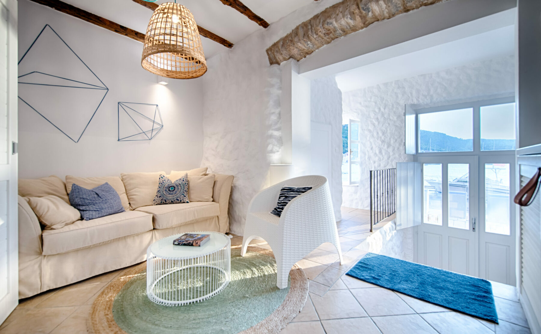 A cozy corner featuring natural textures, warm lighting, and artistic decor. This intimate space combines rustic beams with modern furnishings, creating a perfect balance of comfort and design.