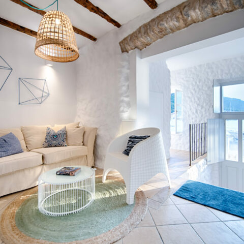 A cozy corner featuring natural textures, warm lighting, and artistic decor. This intimate space combines rustic beams with modern furnishings, creating a perfect balance of comfort and design.