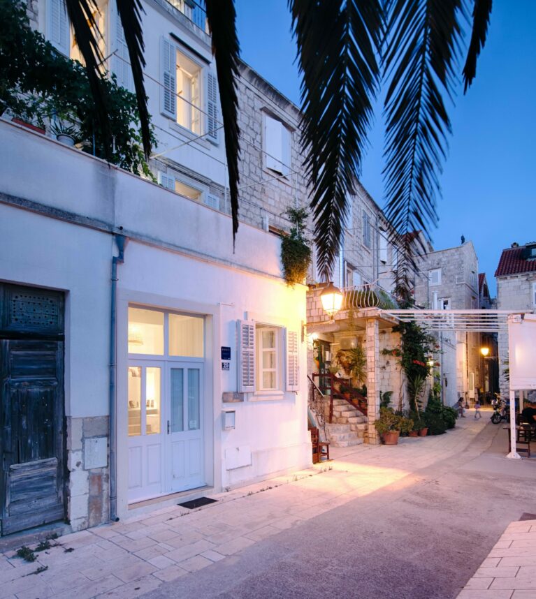 The villa’s pristine white facade reflects its historic charm and modern refresh. Nestled in a picturesque village, its understated elegance blends seamlessly with the surrounding coastal architecture and cobbled streets.