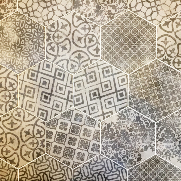 Intricate encaustic tiles add personality and texture to the bathroom. This geometric and floral mix introduces a touch of Mediterranean artistry, creating a striking focal point.