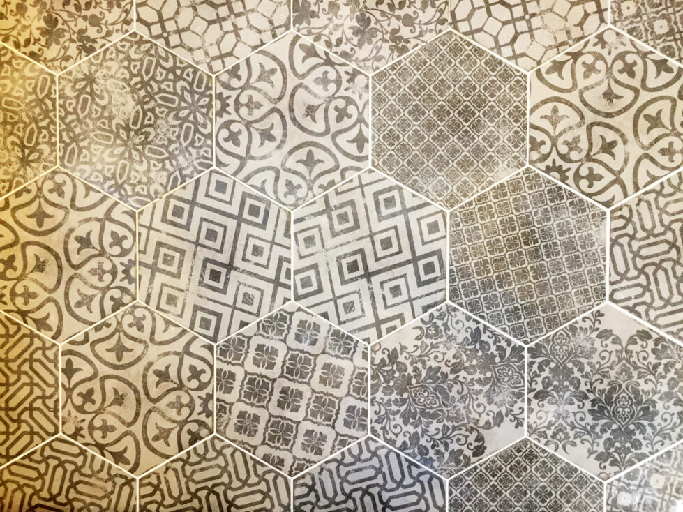 Intricate encaustic tiles add personality and texture to the bathroom. This geometric and floral mix introduces a touch of Mediterranean artistry, creating a striking focal point.