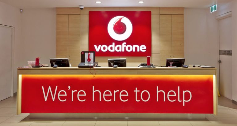 Vodafone welcoming desk, corporate logo, timber counter top