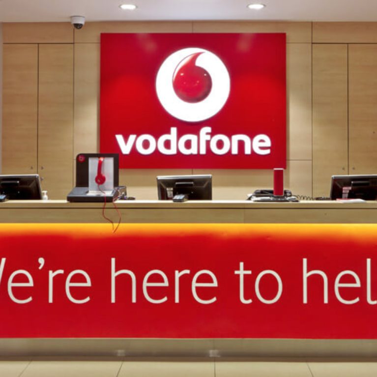 Vodafone welcoming desk, corporate logo, timber counter top