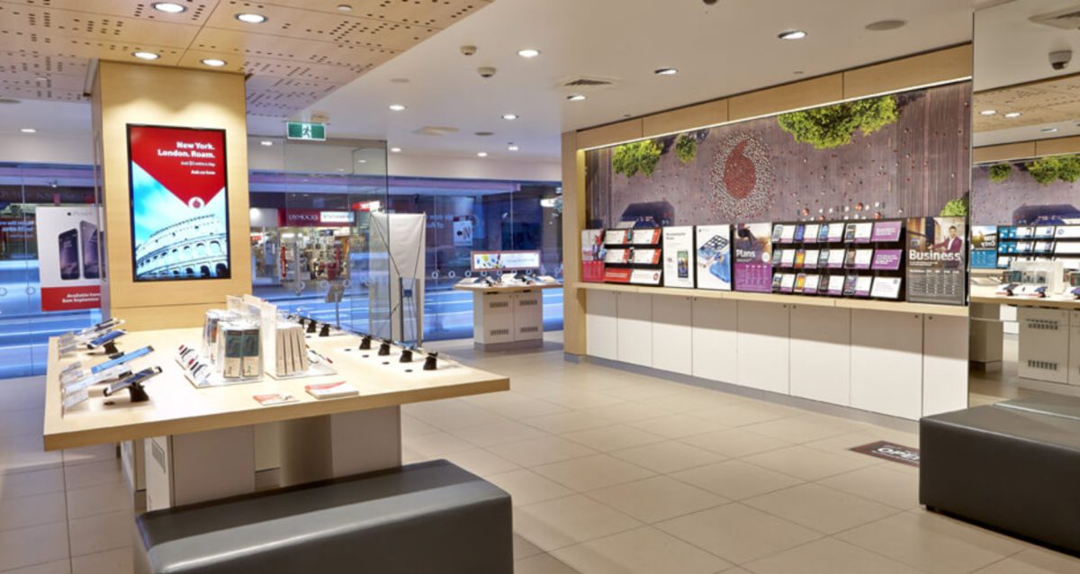 A comprehensive view of the Vodafone store, showcasing sleek counters, organized product displays, and a bright, modern retail layout.