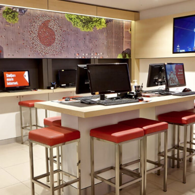 high table with computers for Vodafone store customer service